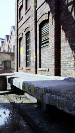 a brick building with a concrete walkway in front of it