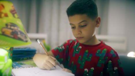 child doing homework at night on his desk