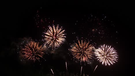 Farbenfrohe,-Echte-Feuerwerksfeier-Am-Silvesterabend-Mit-Einer-Abstrakten-Unschärfe-Aus-Goldenem-Glanz-Und-Bokeh-Lichtern-Am-Nachthimmel