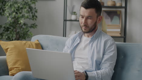 man working on laptop at home