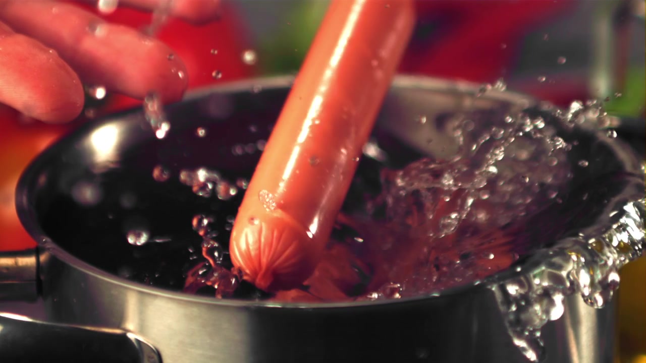 Slow Motion of Hot Dogs Dropping into a Pot of Water