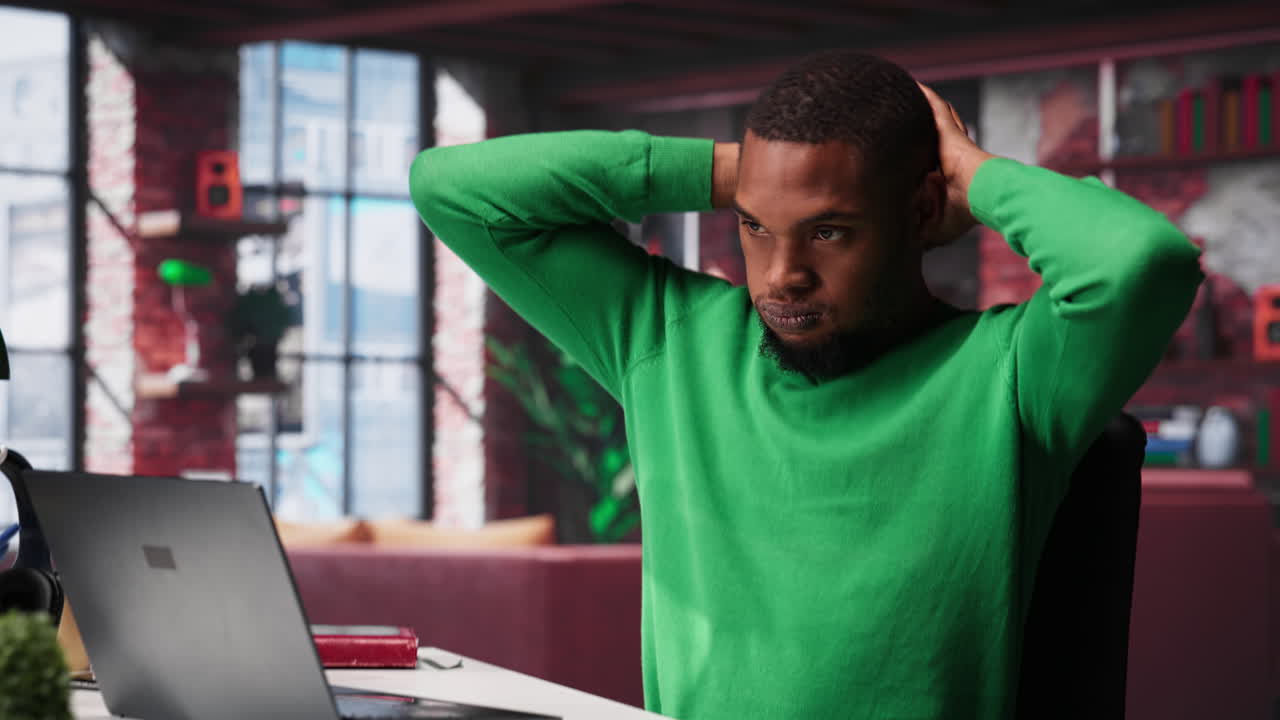 Vertical Video Teleworker fixing his back posture and suffering a muscle cramp at home desk