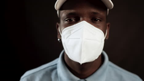 Portrait-Of-African-Man-Putting-On-Protective-Face-Mask