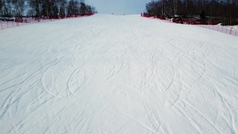 snowy ski slope with ski tracks