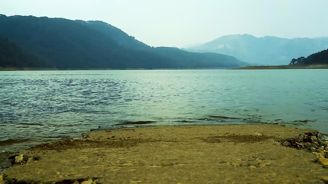 lake shore with mountain background at morning from flat angle