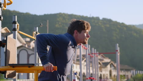 man doing pull-ups outdoors