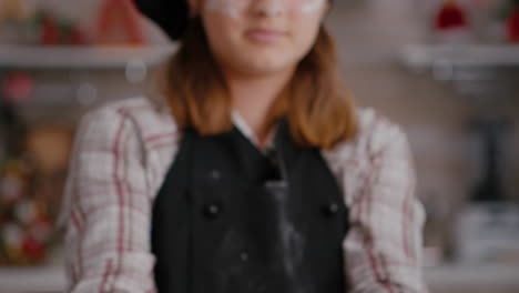 Selective-focus-of-grandchild-holding-cookie-dough-with-heart-shape-in-hands