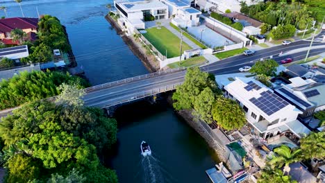 a boat navigates scenic canals in broadbeach, qld