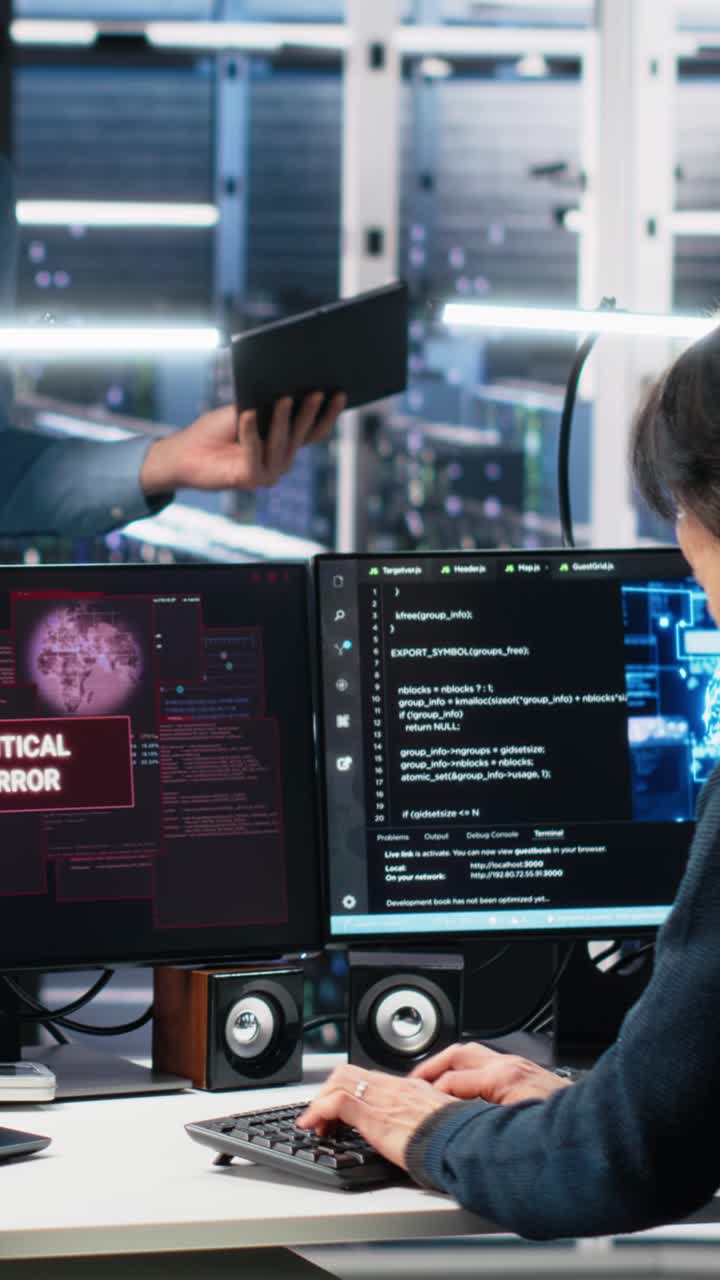 Vertical video Data center manager coordinates programmers fixing critical error while using AI