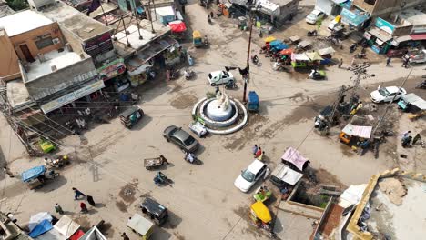 aerial view of roundabout with traffic going past in badin city in sindh, pakistan
