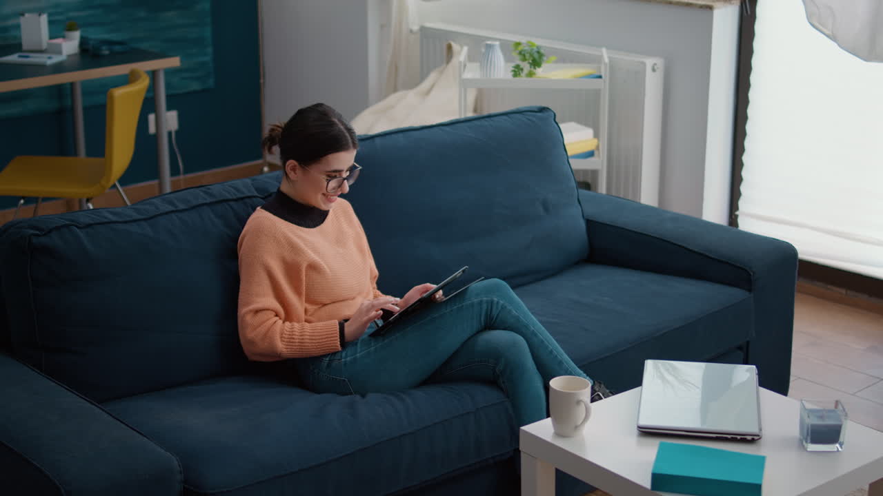 Female student using digital tablet to do remote school work