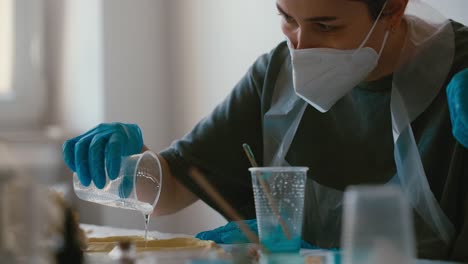 woman pouring resin