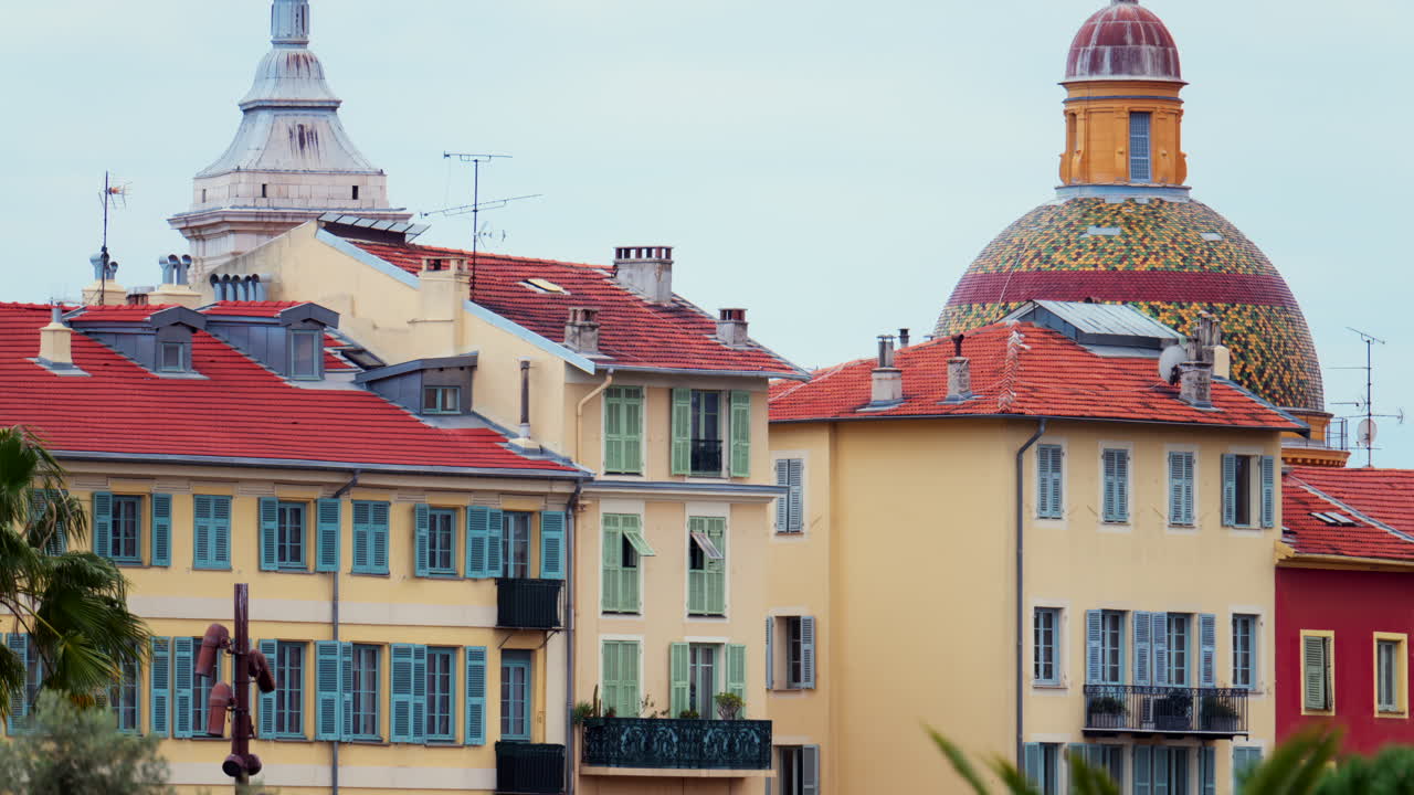 Colourful buildings and trees in the skyline of Nice, France on a cloudy day