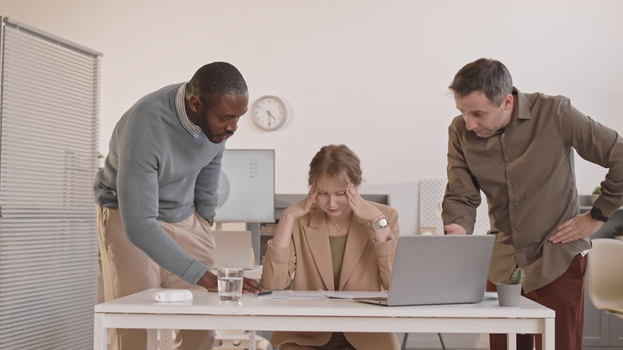 Woman Overwhelmed by Colleagues in Office