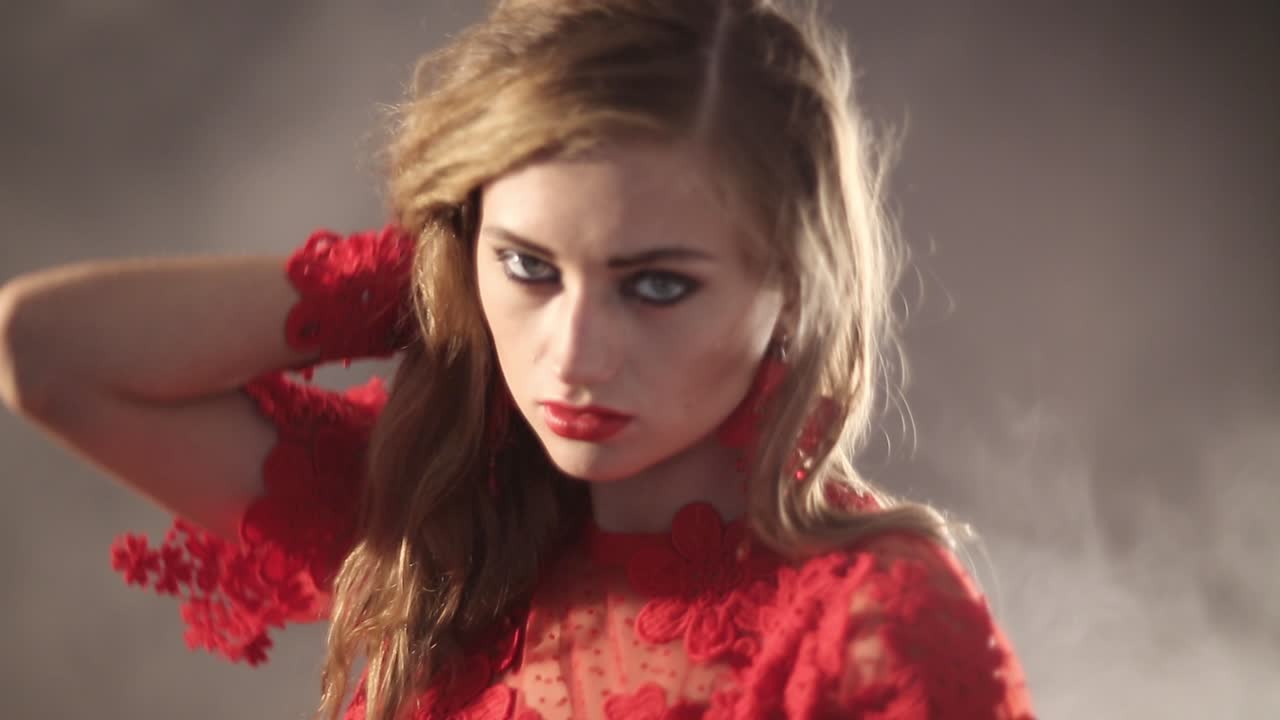 Beauty Woman On The Fog. Beauty woman in long red dress on the fog