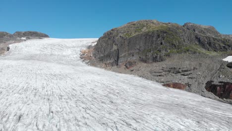 Aerial:-receding-glacier-in-Norway-mountains,-global-warming-climate-change