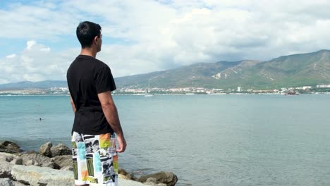 man looking at the sea view