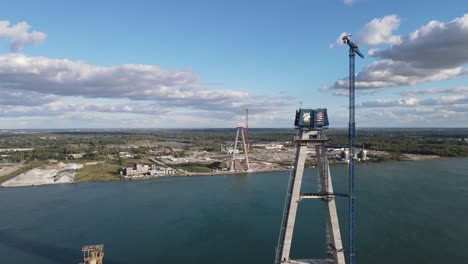 Two-towers-of-bridge-connecting-USA-and-Canada,-construction-site,-aerial-view