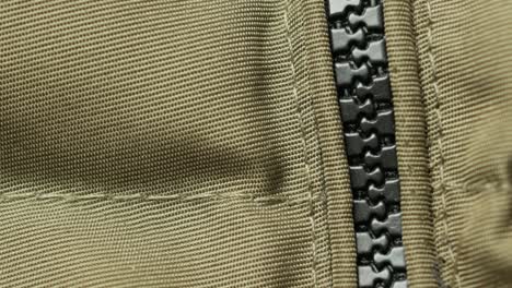 close-up of a zipper on a green fabric