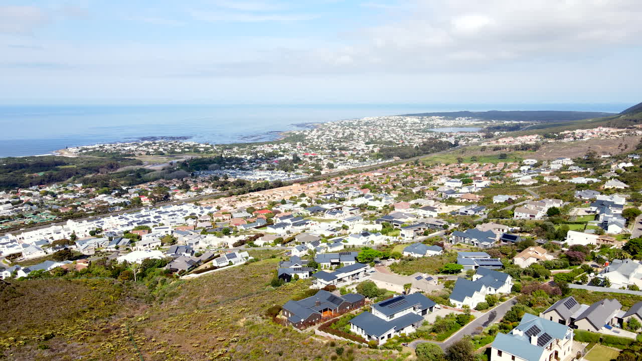 Chanteclair suburb in Onrus on mountainside with wide ocean views, aerial pan