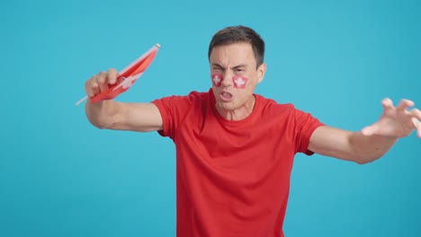 man cheering for switzerland, angry with the decision of referee