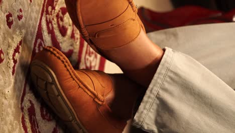 man's feet in loafers on carpet