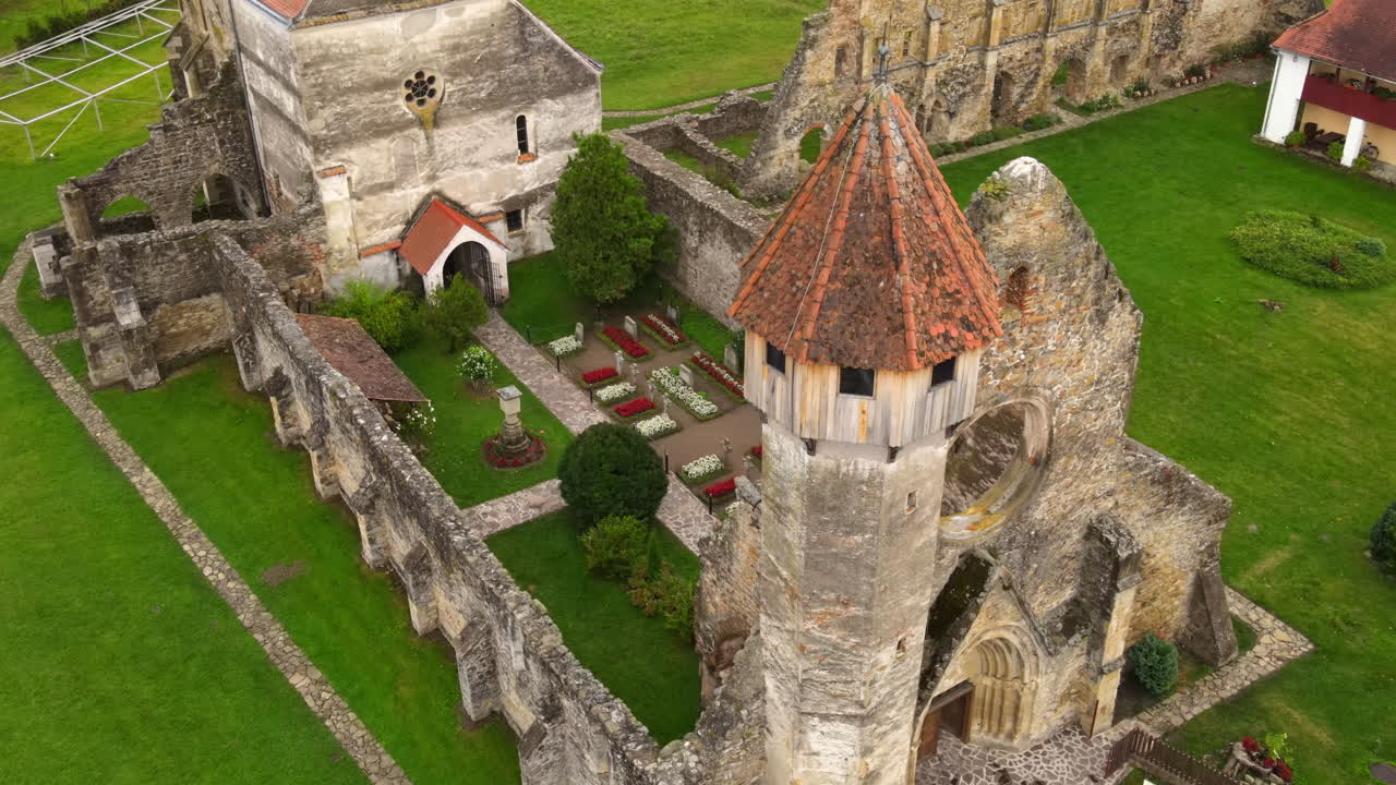 Aerial drone view of the ruins of medieval Cistercian abbey in Romania. Carta Monastery, medieval buidlings, greenery