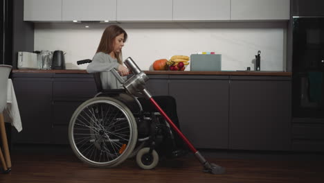 young woman in wheelchair takes care of house keeping clean