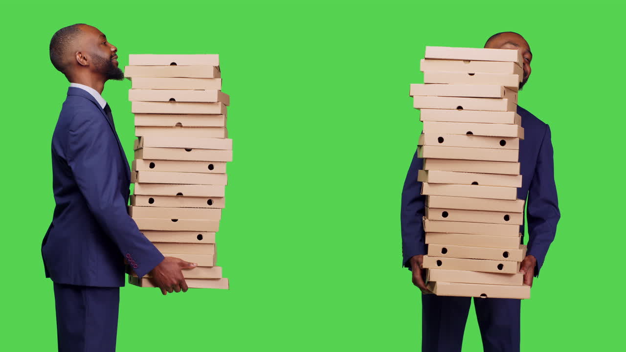 Men carrying stacks of pizza boxes
