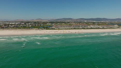 A-kitesurf-event-in-front-of-Dolphin-Beach-near-Cape-Town,-aerial-shot