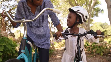 mother and daughter are preparing to riding bike