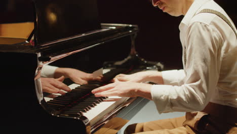 man playing grand piano