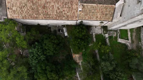 drone shot of mljet fortress inner courtyard with greenery and stone walls in croatia. top-down aerial reveal frame