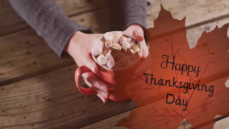 animation of happy thanksgiving day text over caucasian woman with cup of hot chocolate