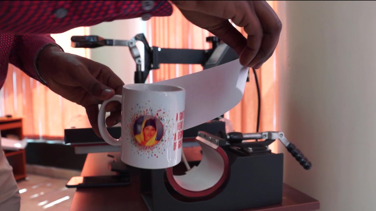 mug-cup printing machine at work.