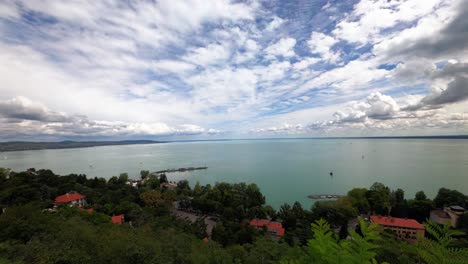 Spectacular-timelapse-video-from-Hungary,-Tihany-peninsula,-with-the-view-of-the-northern-shore-of-Lake-Balaton-and-the-ferry-port-with-many-sailing-boats-in-the-background