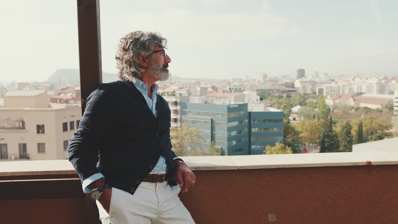 Man admiring the city view from a balcony