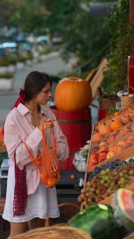 woman shopping for fruit at a farmers market