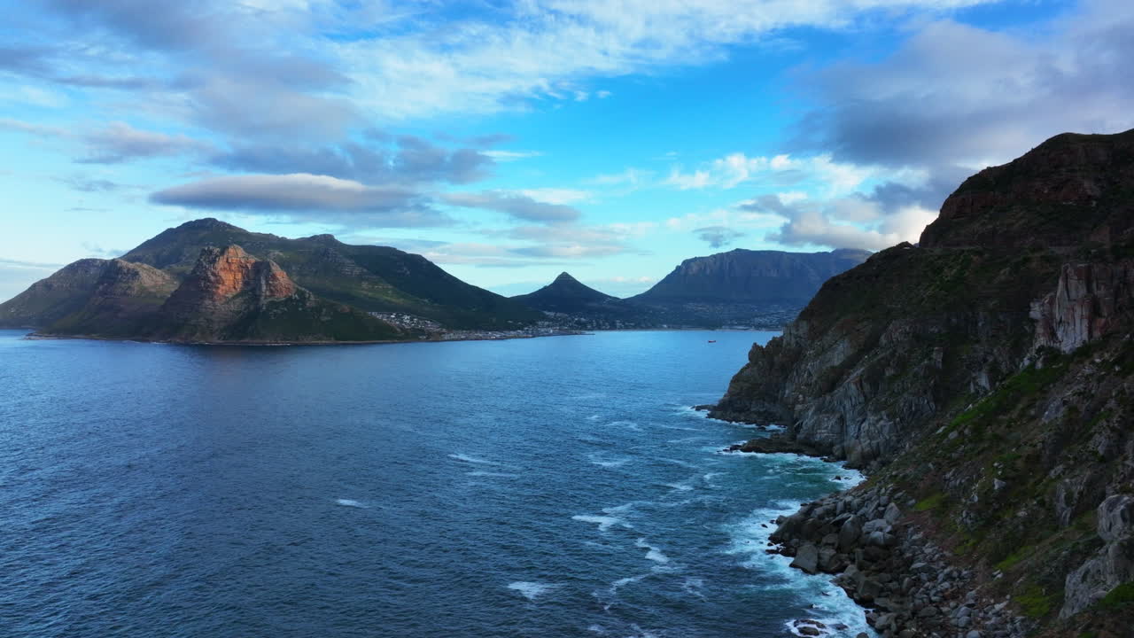 Chapman Peak South Africa sunset drive aerial cinematic drone Hout Bay marina Cape Town Fish Hoek Good Hope Simon's Town waves crashing rugged coast aqua deep blue water lush green summer left motion