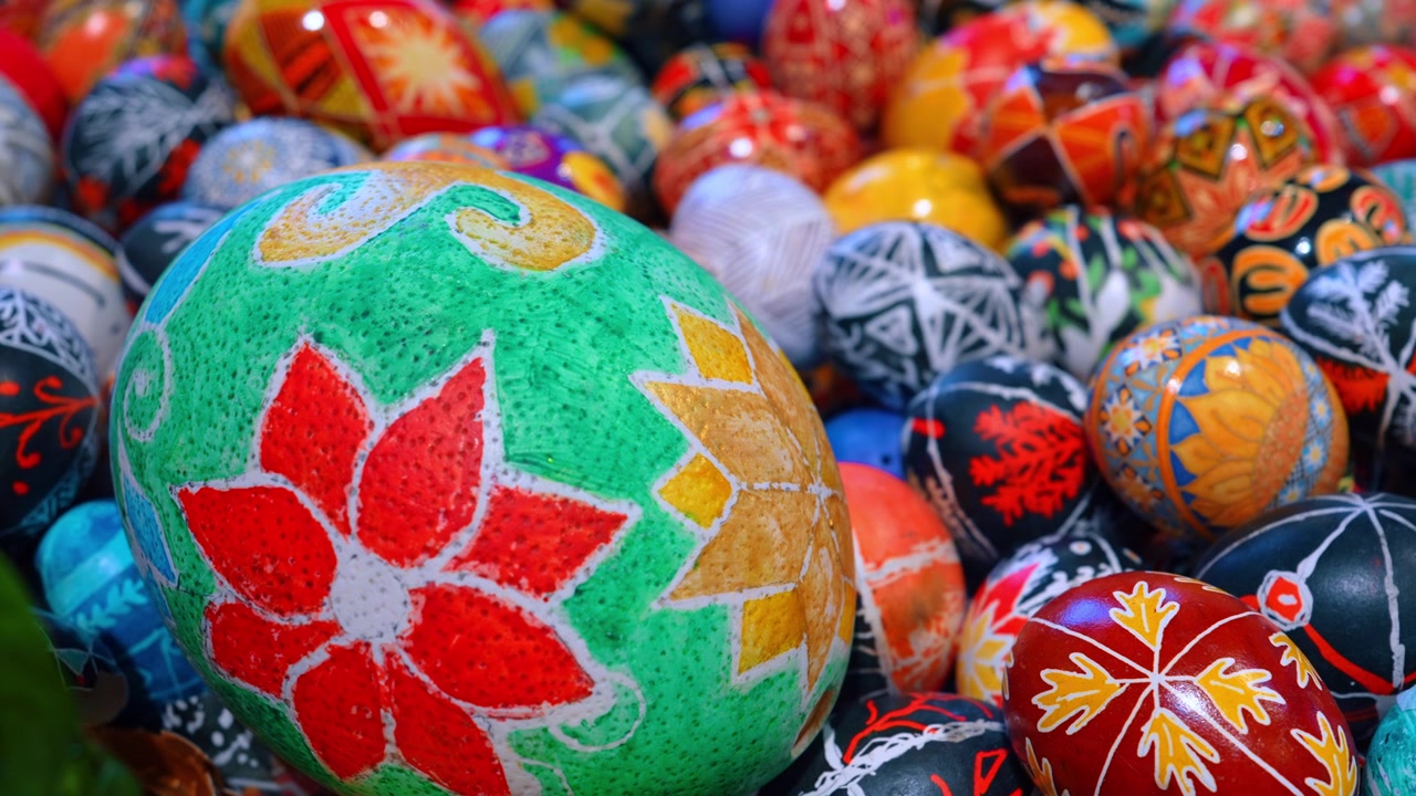 Colorful traditional Ukrainian Easter eggs pysanky collection. Extreme close-up of various hand-painted Ukrainian Easter eggs with intricate floral and geometric patterns.