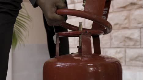 liquefied petroleum gas cylinder refilling and gas leakage through valve close up at day