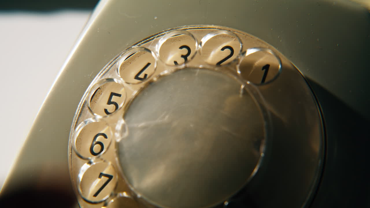 Hand rotating phone dial at stationary device at home closeup. Finger turning