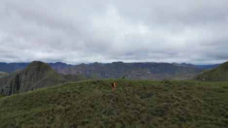 panoramic view of hiker on rugged mountainous codo de los andes trail