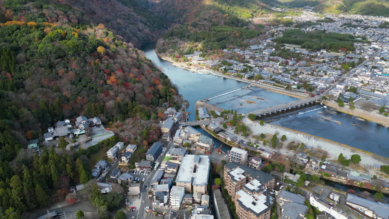 Aerial view tilting toward the Katsura river, sunny, fall day in Kyoto, Japan