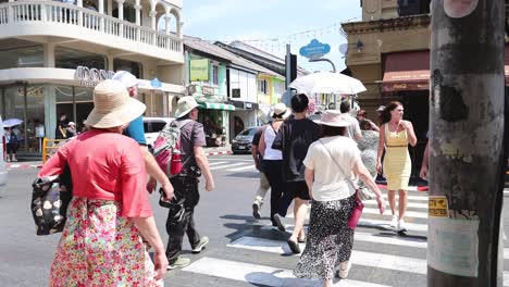 people crossing the street on a sunny day