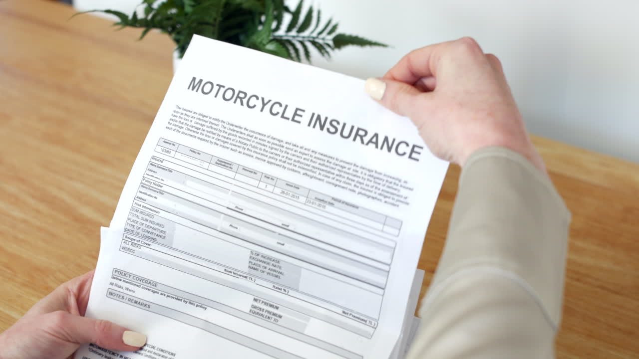 A woman opening a motorcycle Insurance Document letter outlining her policy and cover details