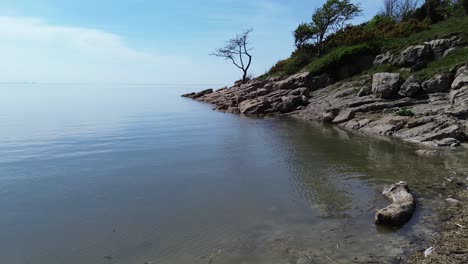 calming paradise rocky shoreline aerial view across dreamlike blue sky seascape stillness