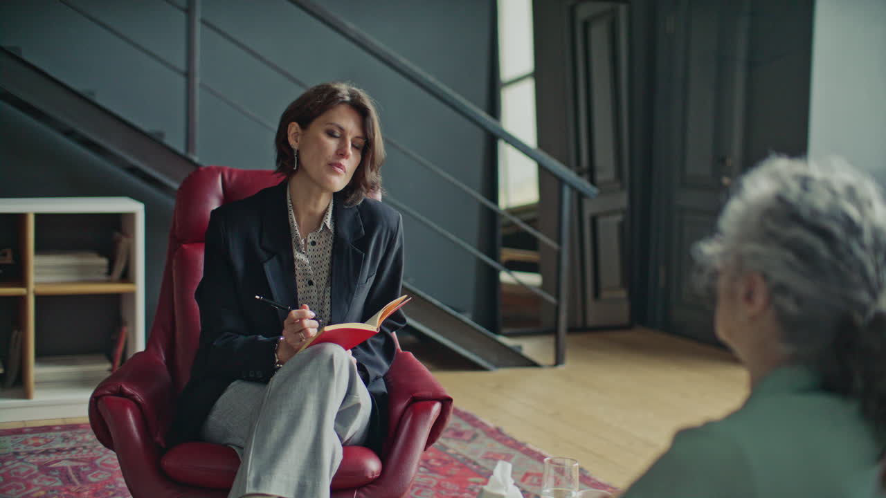 Female Psychologist Giving Mental Health Consultation to Patient in Office