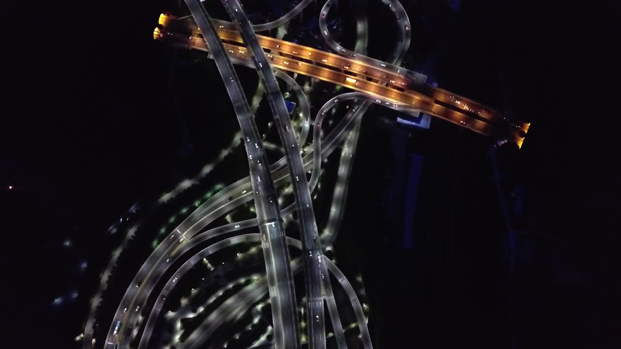 Top Down Aerial View of Night Traffic on Roads in Guangzhou, China. Illuminated Roads and Cars. High Angle Drone Shot