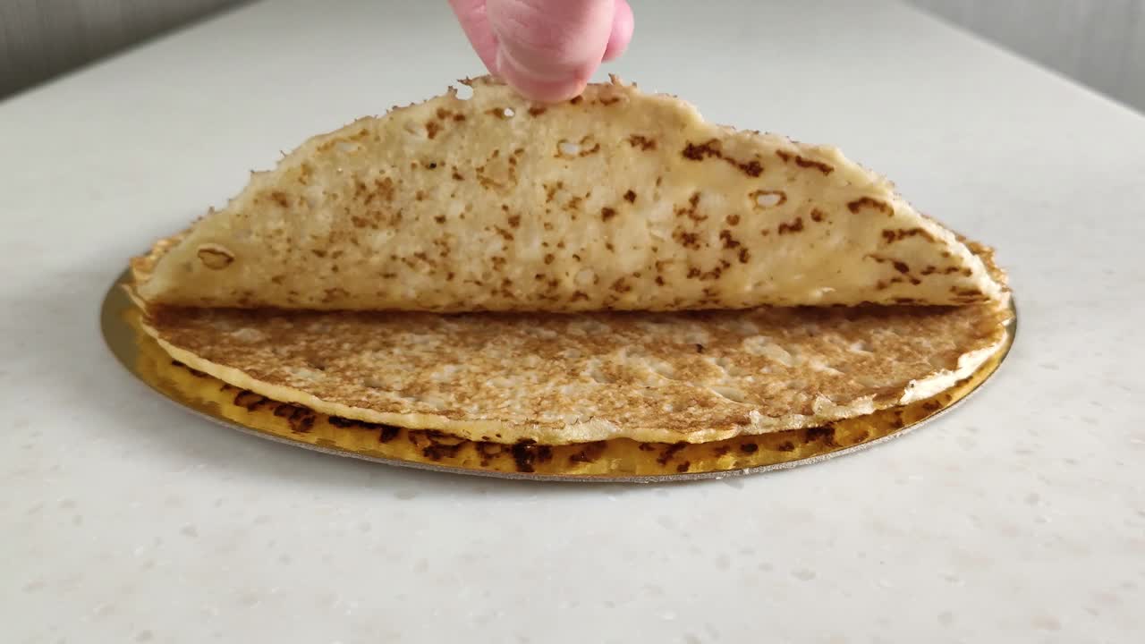 Thin pancakes on marble table
